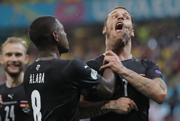 epa09268205 Marko Arnautovic (R) of Austria celebrates with team-mate David Alaba after scoring the 3-1 goal during the UEFA EURO 2020 group C preliminary round soccer match between Austria and North  ...