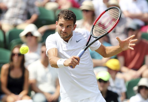 Bulgaria&#039;s Grigor Dimitrov returns a ball to Marcos Baghdatis of Cyprus during their Men&#039;s Singles Match at the Wimbledon Tennis Championships in London Thursday, July 6, 2017. (Gareth Fulle ...