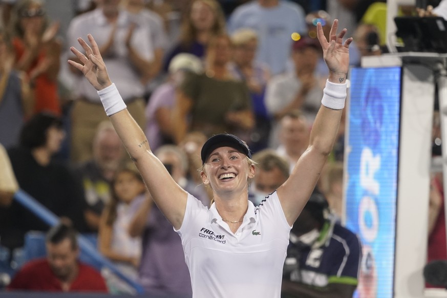 Jil Teichmann, of Switzerland, smiles after defeating Naomi Osaka, of Japan, during the Western &amp; Southern Open tennis tournament Thursday, Aug. 19, 2021, in Mason, Ohio. (AP Photo/Darron Cummings ...