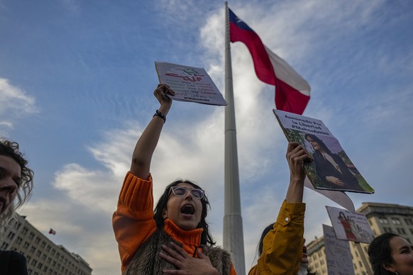 Iranians nationals and local feminists protest against the death of Iranian Mahsa Amini, in front of the La Moneda presidential palace in Santiago, Chile, Friday, Sept. 23, 2022. The 22-year-old, who  ...