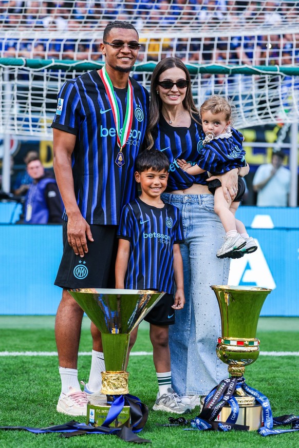 FC Internazionale vs Hellas Verona FC, Serie A football, Milano, Italy Manuel Akanji of FC Internazionale poses with his family for a photo with the Coppa Campioni d Italia and Coppa Italia trophies f ...