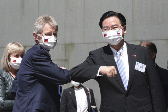 Czech Senate President Milos Vystrcil, front left, is greeted by Taiwanese Foreign Minister Joseph Wu as he arrives for delivering a speech at National Chengchi University in Taipei, Taiwan, Monday, A ...