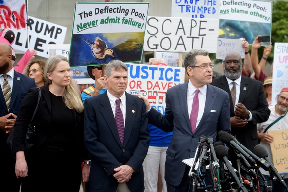 Former Olympic canoeist David Hearn, second from left, listens as his attorney Norman Eisen, right, speaks after he pleaded not guilty to allegedly damaging the Lincoln Memorial Reflecting Pool, Thurs ...