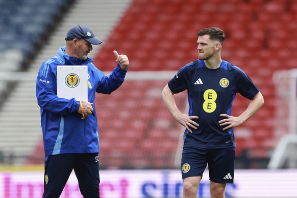 Scotland manager Steve Clarke and Andrew Robertson gesture, during a training session at Hampden Park, Glasgow, Scotland, Thursday June 6, 2024, ahead of a friendly soccer match against Finland on Fri ...
