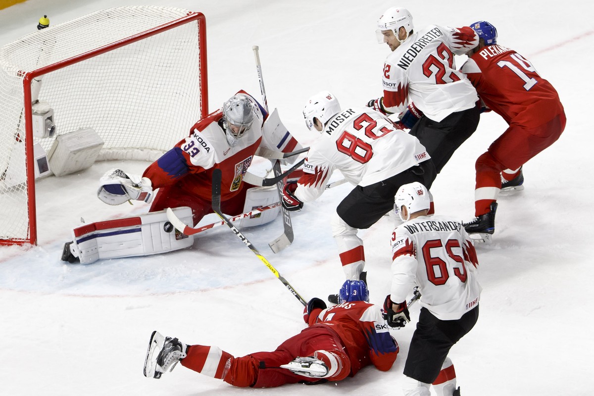 Czech Republic's goaltender Pavel Francouz, left, saves a the puck past Czech Republic's defender Radko Gudas #3, Switzerland's forward Simon Moser #82, Switzerland's defender Ramo ...