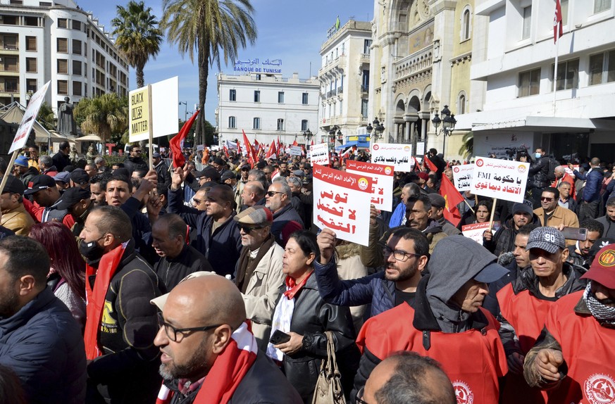 Members of the Tunisian General Labor Union (UGTT) take part in a protest against president Kais Saied policies, in Tunis, Tunisia, Saturday, March 4, 2023. Banner in Arabic reads &quot;Tunisia can&#0 ...