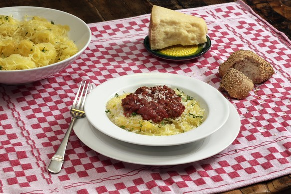 This Dec. 8, 2016 photo shows baked spaghetti squash with meat sauce at the Institute of Culinary Education in New York. This dish is from a recipe by Elizabeth Karmel. (AP Photo/Richard Drew)