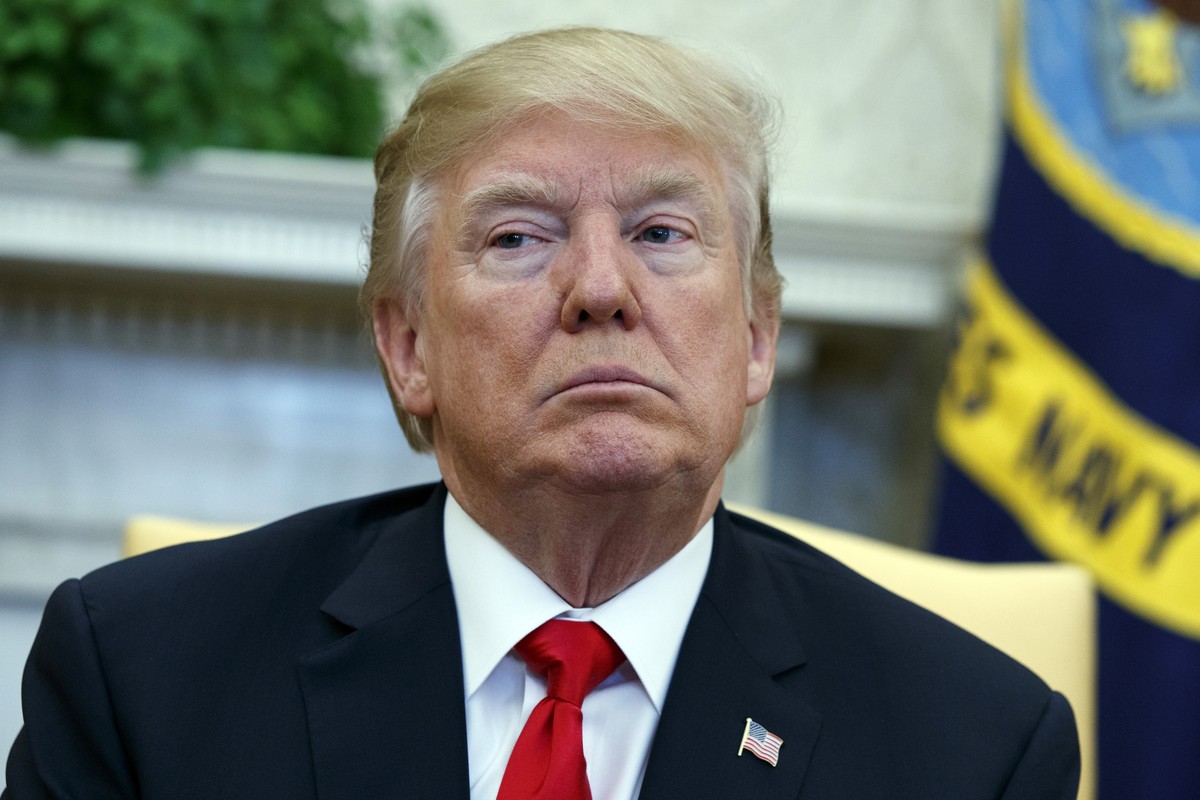 President Donald Trump listens during a meeting with North Korean defectors where he talked with reporters about allowing the release of a secret memo on the FBI's role in the Russia inquiry, in  ...