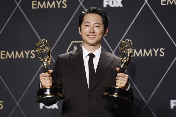 epa11081305 American actor Steven Yeun, winner of Outstanding Lead Actor In A Limited Or Anthology Series Or Movie and Outstanding Limited Or Anthology Series for 'Beef', poses in the press room d...
