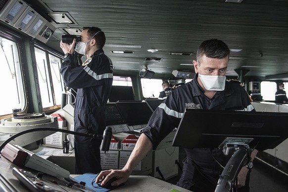 This photo provided Saturday April 10, 2020 by the French Navy (Marine Nationale) shows sailors wearing face masks aboard the French aircraft carrier Charles de Gaulle, Thursday April 8, 2020 in the A ...