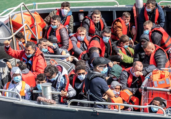 epa10105607 Migrants arrive in a Border Force Volunteer rescue boat, which has escorted 90 migrants picked up in the English Channel by Border Force in Dover, Britain, 04 August 2022. A report from th ...