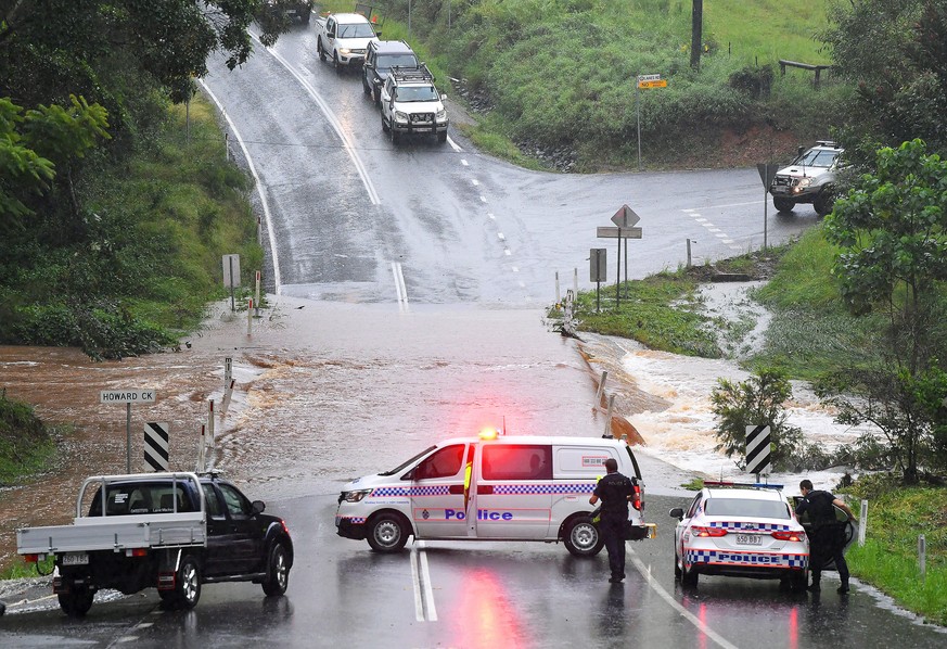 epa09089264 A flooded causeway at Howard creek blocks access to Tamborine Mountain in the Gold Coast hinterland, Australia, 22 March 2021. The weather bureau is warning of potentially life-threatening ...