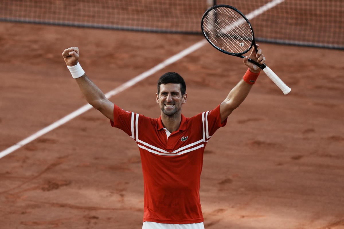 Serbia's Novak Djokovic celebrates as he defeats Stefanos Tsitsipas of Greece during their final match of the French Open tennis tournament at the Roland Garros stadium Sunday, June 13, 2021 in P ...