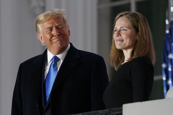 FILE - President Donald Trump and Amy Coney Barrett stand on the Blue Room Balcony after Supreme Court Justice Clarence Thomas administered the Constitutional Oath to her on the South Lawn of the Whit ...