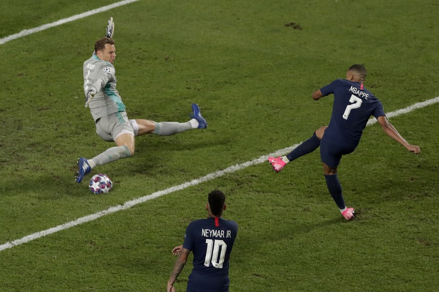 Bayern's goalkeeper Manuel Neuer saves a shot by PSG's Kylian Mbappe during the Champions League final soccer match between Paris Saint-Germain and Bayern Munich at the Luz stadium in Lisbon ...