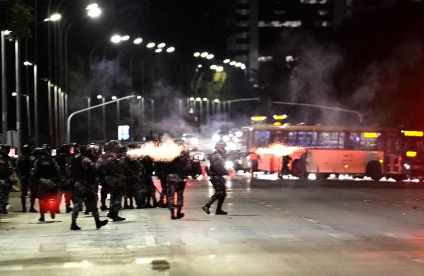 Supporters of Brazilian President Jair Bolsonaro clash with police setting fire to several vehicles and allegedly trying to storm the headquarters of the Federal Police in Brasilia, Brazil, Monday, De ...