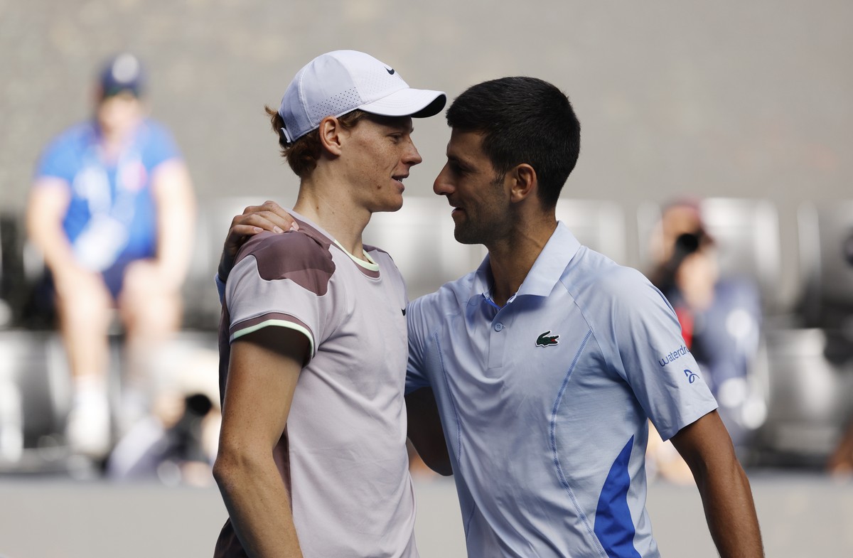 epa11105016 Jannik Sinner of Italy and Novak Djokovic of Serbia hug after Sinner's victory in the Men's semi final match at the Australian Open tennis tournament in Melbourne, Australia, 26  ...
