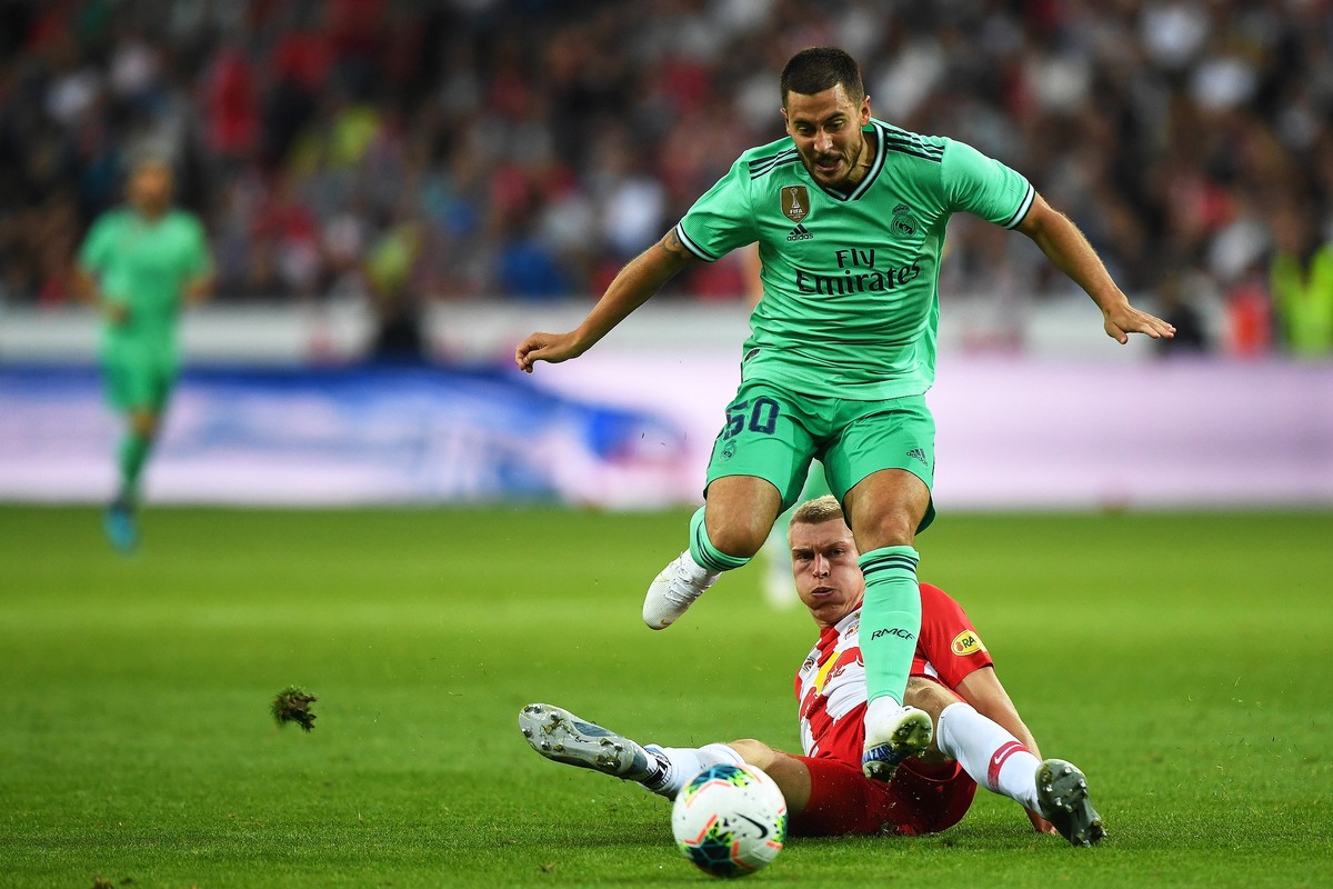 epa07760950 Salzburg's Rasmus Kristensen (bottom) in action against Real Madrid's Eden Hazard (up) during the friendly soccer match between FC Red Bull Salzburg and Real Madrid in Salzburg,  ...