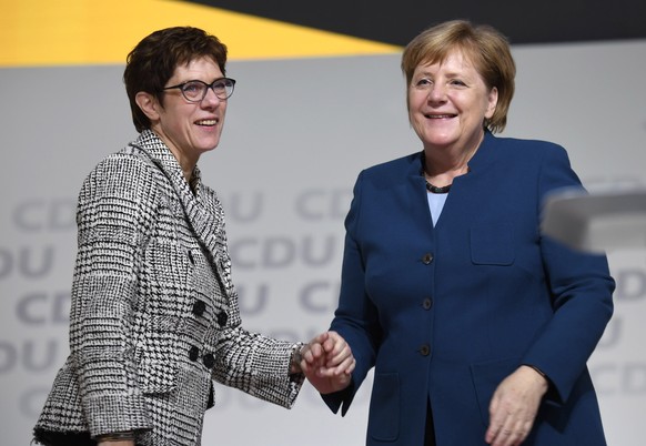 epa07215167 The elected chairwoman Annegret Kramp-Karrenbauer (L) is congratulated by German Chancellor Angela Merkel (R), after winning the run-off of the election of a new party leader during the 31 ...