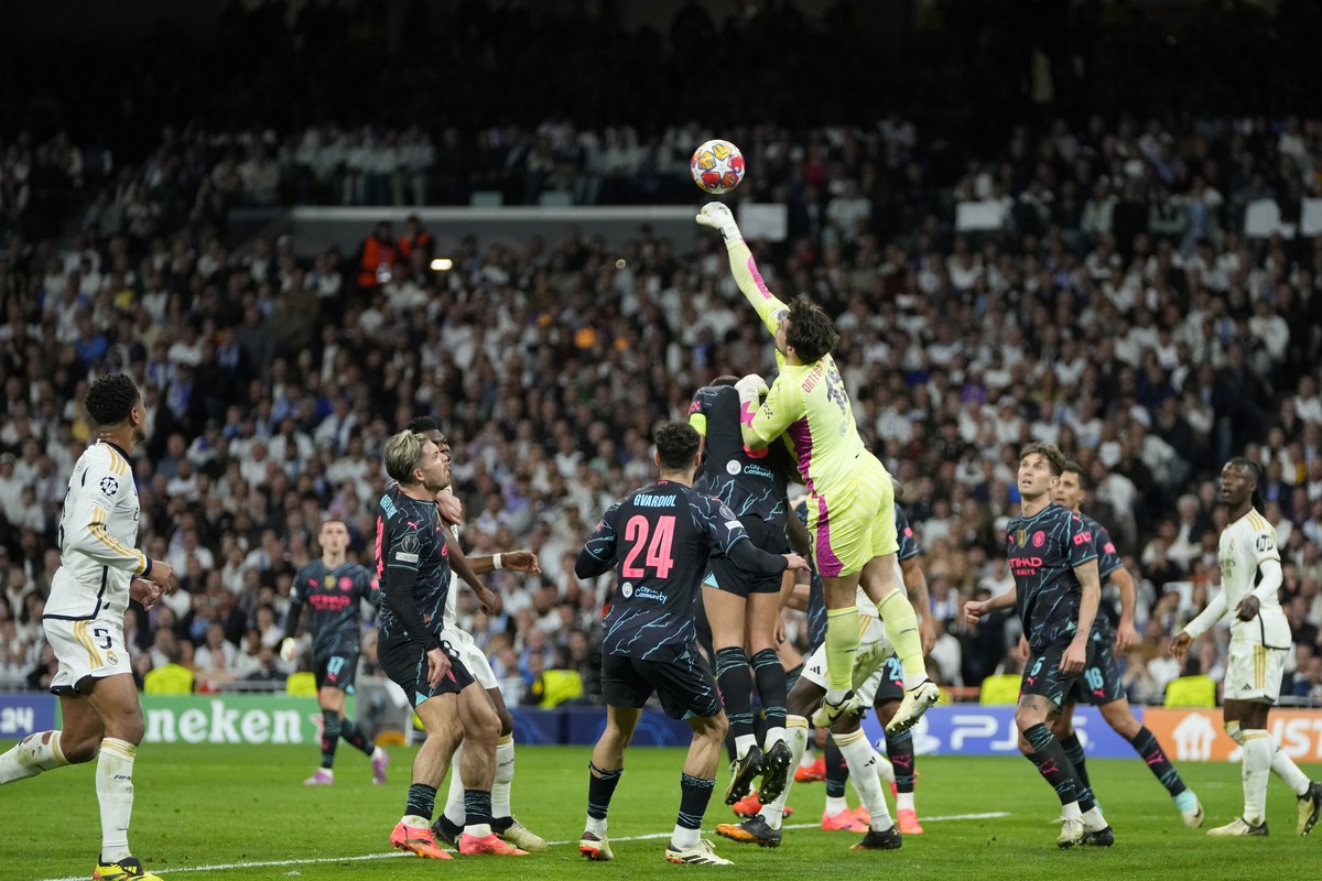Manchester City's goalkeeper Stefan Ortega jumps for the ball during the Champions League quarterfinal first leg soccer match between Real Madrid and Manchester City at the Santiago Bernabeu stad ...