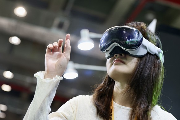 epa11338407 A person uses an Apple Vision Pro glasses during the &#039;CYBERSEC 2024&#039; cyber security expo in Taipei, Taiwan, 14 May 2024. The 10th edition of CYBERSEC 2024, which is held from 14- ...