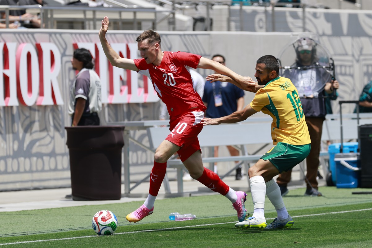 Switzerland's Michel Aebischer, left, and Australia's Aziz Behich in action during a friendly soccer match between Switzerland and Australia at the Snapdragon Stadium in San Diego, Californi ...
