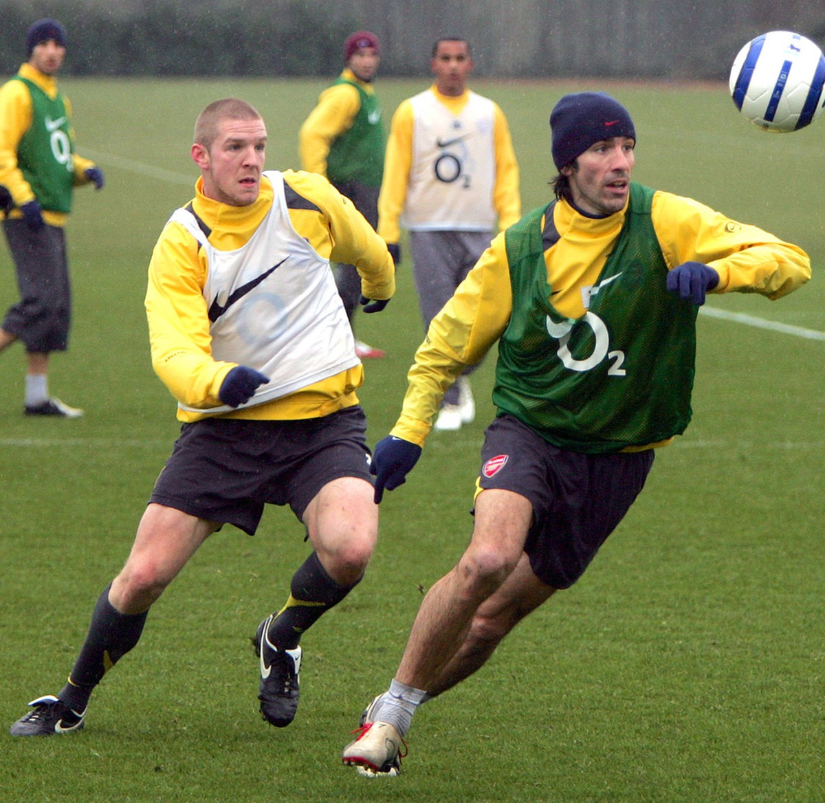 Arsenal's Philippe Senderos, left, looks on as teammate Robert Pires takes the ball away during a training session at the Arsenal training ground in London Colney, England Tuesday March 7 2006. A ...
