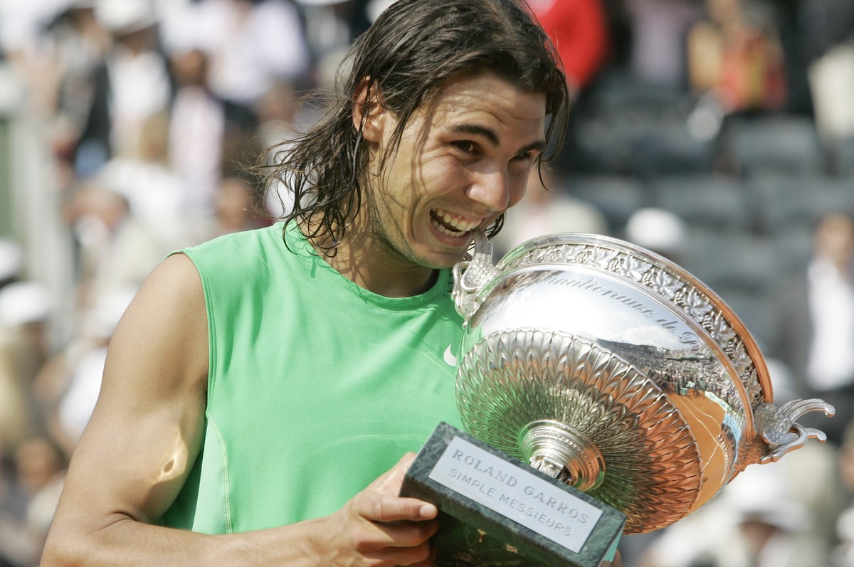 Spain's Rafael Nadal bites his cup after defeating Switzerland's Roger Federer in their men's final match of the French Open tennis tournament, Sunday, June 8, 2008 at the Roland Garros ...
