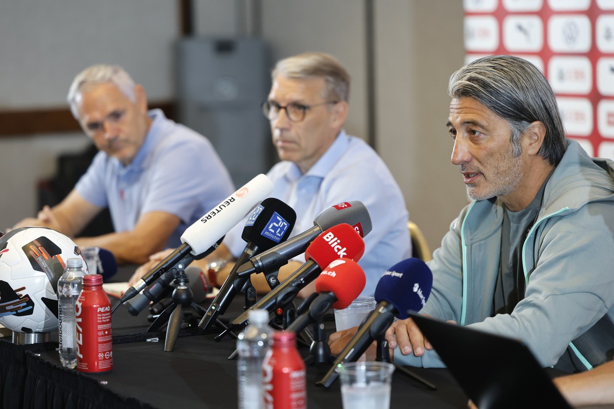Switzerland's head coach Murat Yakin speaks beside Peter Knaebel, President Swiss Football Federation SFV, and team director Pierluigi Tami during a press conference one day after beeing defeated ...