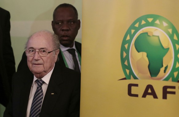 FIFA President Sepp Blatter, left, and Confederation of African Football President Issa Hayatou, back, leave a press conference in Cairo, Egypt, Tuesday, April 7, 2015. Every one of Africa&#039;s 54 m ...