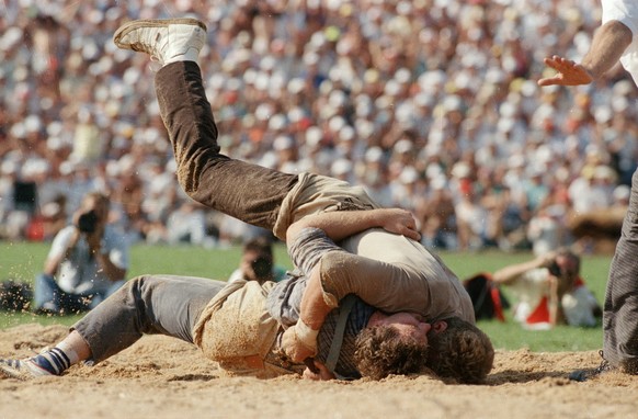 Adrian Kaeser, above, fights Eugen Hasler, beneath, in the final round of the Swiss Wrestling and Alpine Festival, and wins, which makes him the new wrestling champion, pictured in Stans, in the canto ...