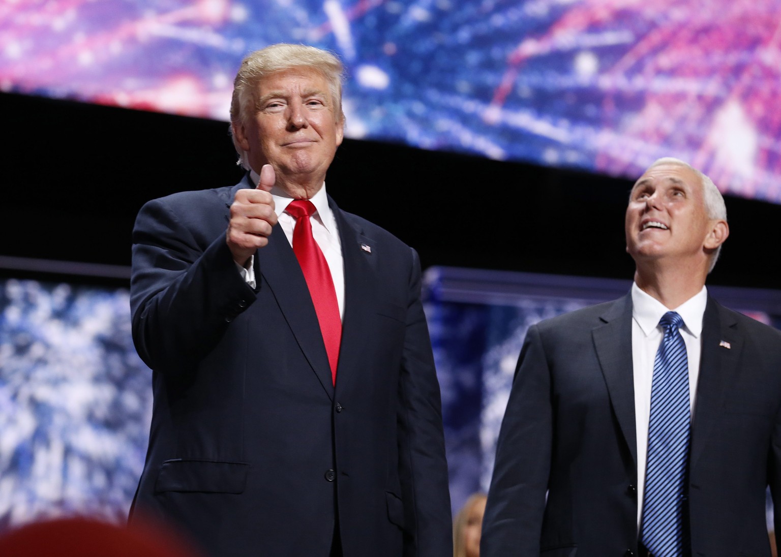 epa05436050 Republican Presidential nominee Donald Trump (L) and Vice Presidential nominee Mike Pence (R) during the final day of the 2016 Republican National Convention at Quicken Loans Arena in Clev ...