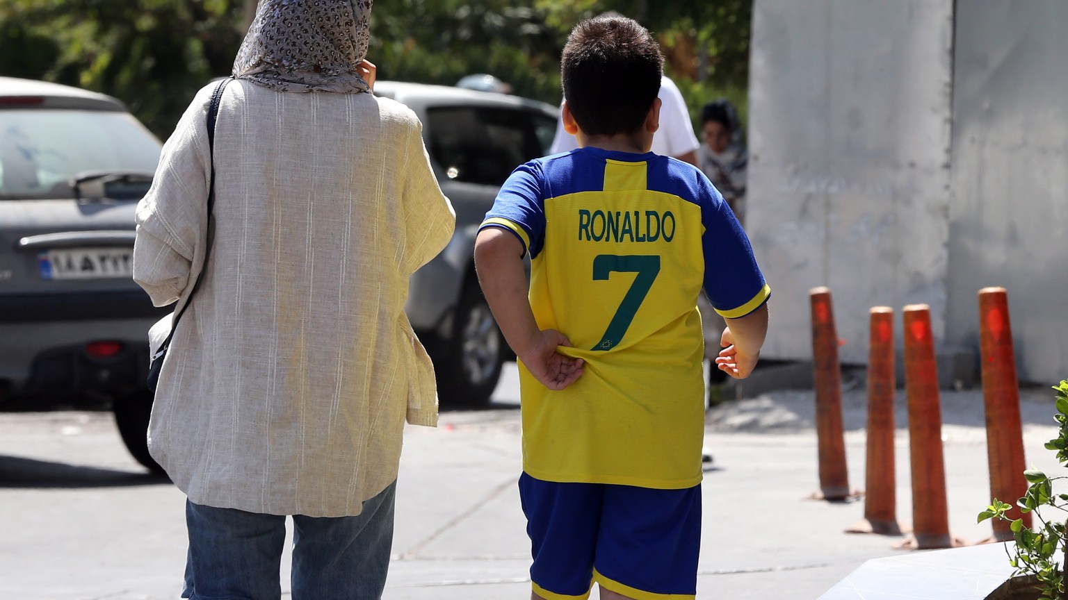 epa10869049 Fans of Al-Nassr player Cristiano Ronaldo wait near the team hotel, where access around the Espinas palace hotel has been blocked by police, in Tehran, Iran, 19 September 2023. Saudi side  ...