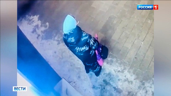 In this image made from video provided by Russian Federal Security Service via Russia-1 TV channel on Sunday, Feb. 8, 2026, CCTV footage showing a person standing outside a building, suspected in the  ...