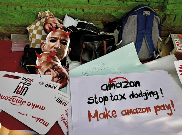 Paper masks in the likeness of Amazon&#039;s Jeff Bezos, and banners wait to be distributed to warehouse workers and delivery drivers as they stage a protest against the Seattle-based company, demandi ...