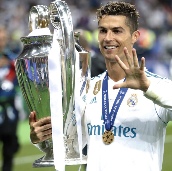 FILE - In this Saturday, May 26, 2018 file photo Real Madrid&#039;s Cristiano Ronaldo celebrates with the trophy after winning the Champions League Final soccer match between Real Madrid and Liverpool ...