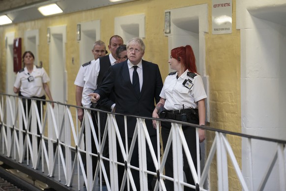 Britain&#039;s Prime Minister Boris Johnson talks with prison staff during a visit to Leeds prison, Northern England, Tuesday Aug. 13, 2019. In an announcement on Sunday Johnson promised more prisons  ...