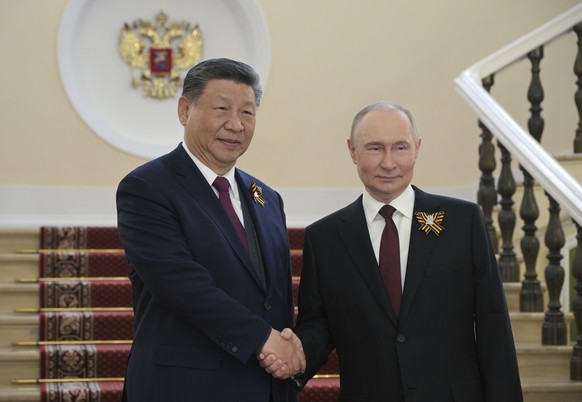 Chinese President Xi Jinping, left, and Russian President Vladimir Putin shake hands during their meeting before the Victory Day military parade in Moscow, Russia, Friday, May 9, 2025, during celebrat ...