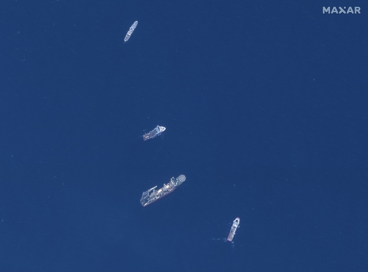 In this satellite image provided by Maxar Technologies, from top to bottom, the vessels L'Atalante, Horizon Arctic, Deep Energy, and Skandi Vinland search for the missing submersible Titan, Thurs ...