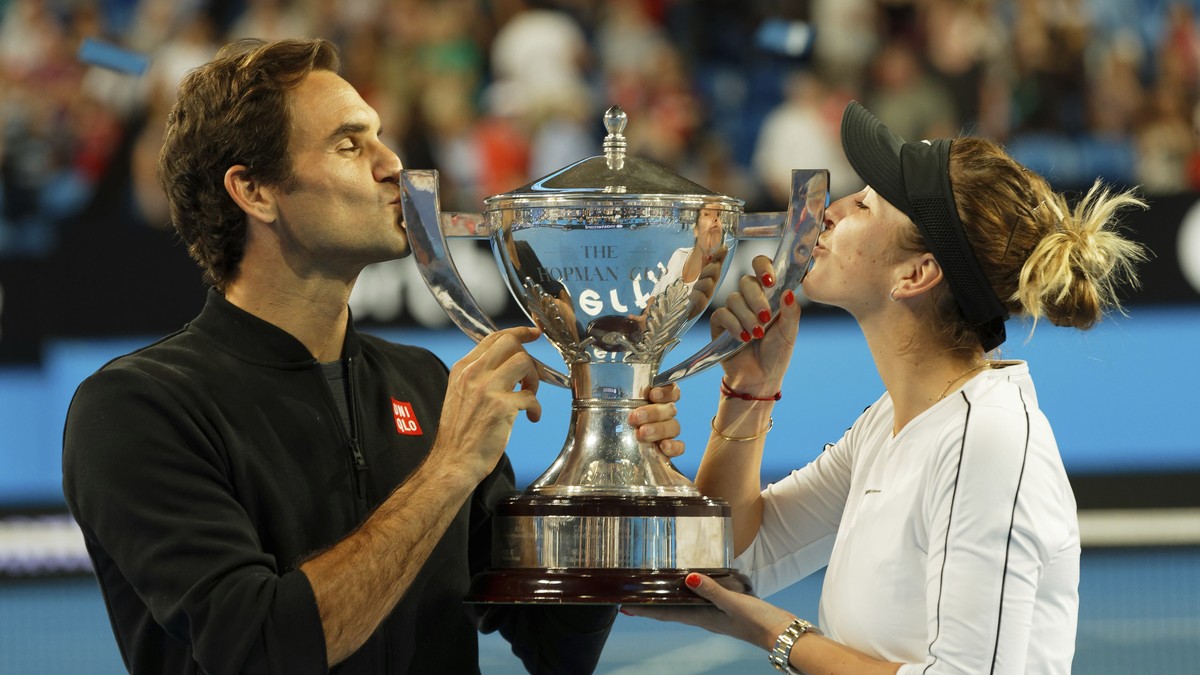 Switzerland's Roger Federer and Belinda Bencic kiss the trophy after winning the final against Alexander Zverev and Angelique Kerber of Germany at the Hopman Cup in Perth, Australia, Saturday Jan ...