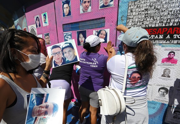epa09949843 Mothers and relatives of disappeared people place images of their loved ones on the fences that surround what was the Glorieta de la Palma in Mexico City, Mexico, 15 May 2022. Relatives an ...