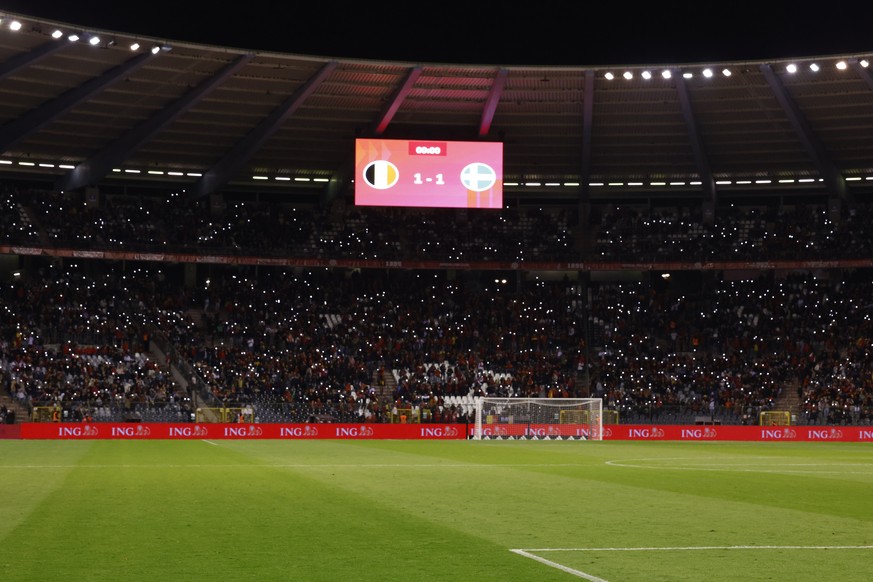 Supporters turned on their mobile phone lights after the suspension of the Euro 2024 Group F qualifying match between Belgium and Sweden at the King Baudouin Stadium in Brussels, Monday, October 8.  16, 2023. ...