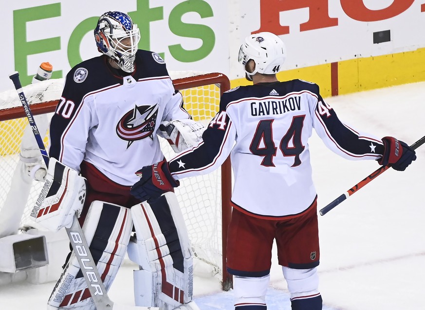 Columbus Blue Jackets goaltender Joonas Korpisalo (70) celebrates with Vladislav Gavrikov (44) after the Blue Jackets defeated the Toronto Maple Leafs in NHL hockey playoff game Sunday, Aug. 9, 2020,  ...