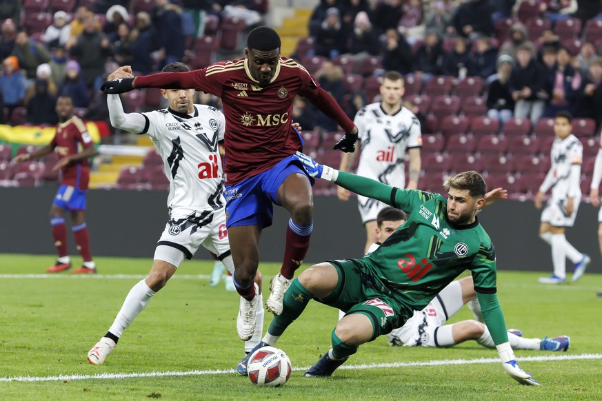 Servette&#039;s forward Chris Bedia, centre, fights for the ball with Lugano&#039;s midfielder Jonathan Sabbatini, left, and Lugano&#039;s goalkeeper Amir Saipi, right, during the Super League soccer  ...