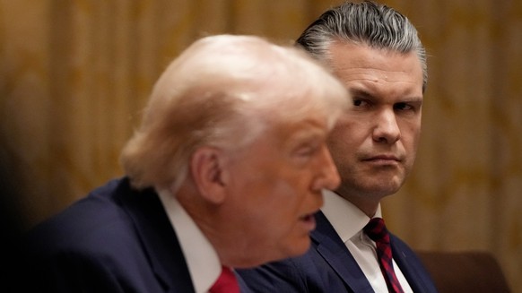 Defense Secretary Pete Hegseth watches as President Donald Trump speaks during a Cabinet meeting at the White House, Tuesday, Dec. 2, 2025, in Washington. (AP Photo/Julia Demaree Nikhinson)