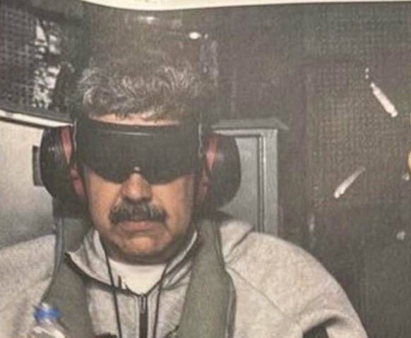 US President Donald J Trump shared on Truth Social a photo of Nicolas Maduro captured and subdued on the American ship, USS Iwo Jima, wearing an eye mask, noise canceling headphones and dressed in a l ...