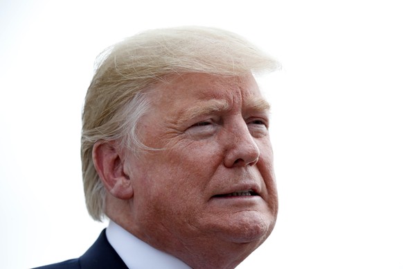 President Donald Trump pauses while speaking to the media as he steps off Air Force One, Tuesday, Aug. 21, 2018, in Charleston, W.Va. (AP Photo/Alex Brandon)