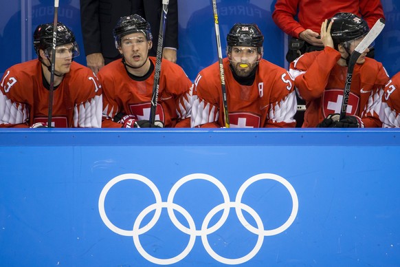 Felicien du Bois of Switzerland, Patrick Geering of Switzerland, Philippe Furrer of Switzerland, and Pius Suter of Switzerland, from left, during the men ice hockey preliminary round match between Swi ...