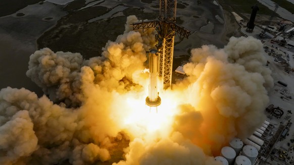 In this photo made available by SpaceX, a Starship first-stage Super Heavy booster performs an engine-firing test at the launch pad in Boca Chica, Texas, on Thursday, Feb. 9, 2023. (SpaceX via AP)