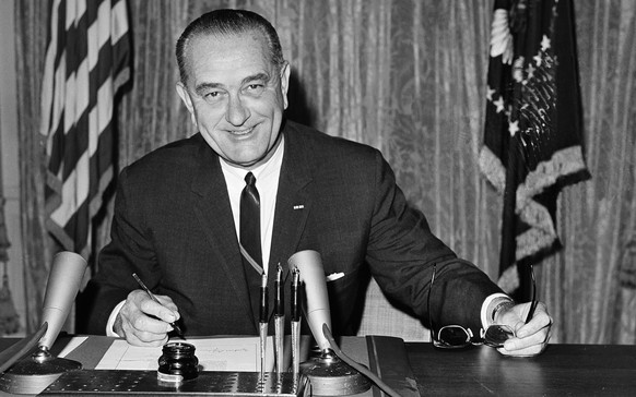 FILE - In this Aug. 10, 1964 file photo, President Lyndon B Johnson signs the Joint Resolution for the Maintenance of International Peace and Security, also known as the Gulf of Tonkin Resolution, bac ...